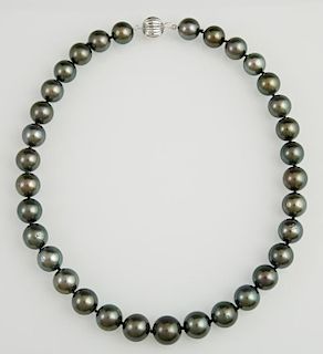 Stand of Thirty-Three Graduated Dark Grey Tahitian Cultured Pearls, ranging from 12-14 mm, with a 14K white gold ball clasp, 