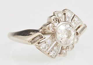 Lady's 14K Yellow Gold Dinner Ring, mid 20th c., with a central round diamond, flanked by small baguettes and round diamonds 
