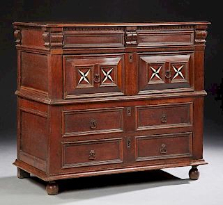 French Inlaid Carved Oak Commode, c. 1880, the rounded edge two board top over a dentillated molding, above two frieze drawer