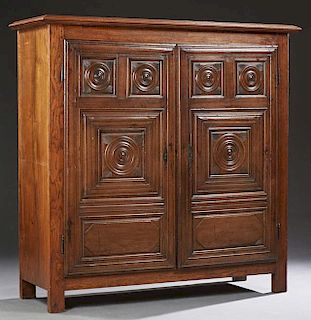 Diminutive French Carved Oak Louis XIII Style Armoire, early 19th c., the stepped crown over double doors with relief carved 