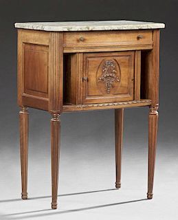 French Louis XVI Style Carved Walnut Marble Nightstand, early 20th c., the rounded edge highly figured creme marble over a fr