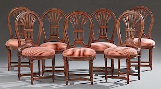 Set of Seven Louis XVI Style Carved Mahogany Dining Chairs, 20th c., the medallion backs with pierced palmette back splat ove