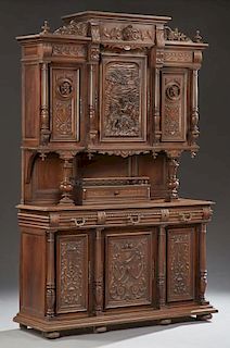 French Henri II Carved Walnut Buffet a Deux Corps, c. 1880, the stepped crown over a figural carved center frieze above a hig