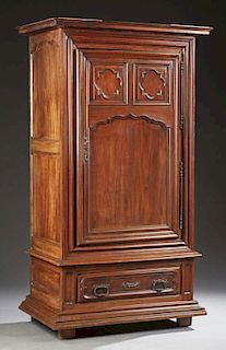 French Louis XIV Style Carved Oak Bonnetiere, early 19th c. the stepped crown over a large triple paneled door, with a long s