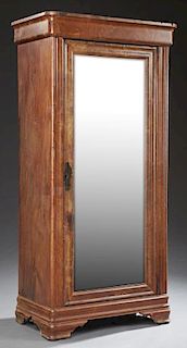 American Carved Mahogany Armoire, 19th c., the rounded corner ogee edge crown over a large mirror door with a wide ogee frame