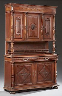 French Henri II Style Carved Walnut Buffet a Deux Corps, 19th c., the stepped crown above a central relief carved door flanke