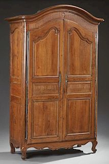 French Louis XV Style Carved Oak Armoire, early 19th c., the arched rounded corner stepped crown over two arched triple field