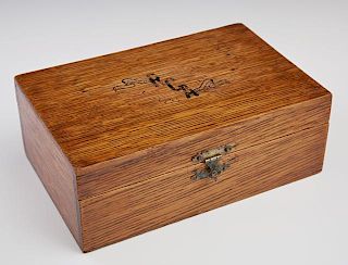 Oak Gambler's Box, 19th c., the compartmented interior with a deck of cards, gambling chips, and dice, theinterior lid with a