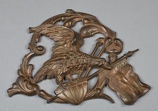 Cast Iron American Flying Eagle Wall Plaque, late 19th c., clutching an American shield and flag, H.- 11 1/2 in., W.- 16 in.,