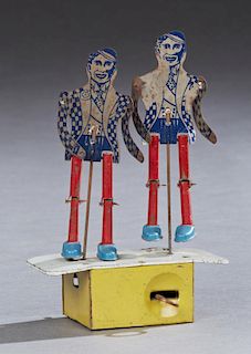 Jitterbug Dancing Black Figures, early 20th c., lithographed tin toy by Chime Toy Products, Canada, working, H.- 8 3/8 in., W
