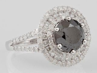 Lady's 14K White Gold Dinner Ring, with a 3.31 carat round black diamond, atop a triple concentric graduated border of round 