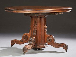 American Victorian Carved Mahogany Circular Dining Table, late 19th c., the stepped top to an octagonal support on quadruped 