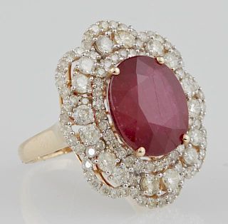 Lady's 14K White Gold Dinner Ring, with an oval 9.61 carat ruby atop a double graduated concentric border of round diamonds a