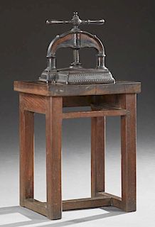 French Cast Iron and Oak Book Press, 19th c., the iron press mounted on a table with square block legs joined by an H-form st