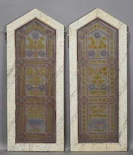 Pair of Painted and Fired Glass Windows, 19th c., of peaked form, with floral decoration, presented in faux marble frames, H.