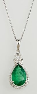 Platinum Pendant, with a pear shaped 2.2 carat emerald atop a border of tiny round diamonds, beneath an integral diamond moun
