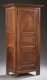Diminutive French Provincial Carved Oak Bonnetiere, 19th c., the stepped crown over a triple fielded panel door with iron fic