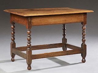French Carved Oak Coffee Table, 20th c., the stepped top on a wide skirt to turned block legs, on ball feet joined by stretch