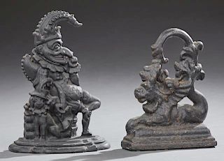 Two Cast Iron Doorstops, c. 1880, one of Punch and his dog; the second of a winged recumbent lion, Punch- H.- 12 1/2 in., W.-