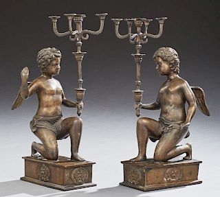 Pair of Patinated Bronze Five Light Candelabra, 20th c., with a kneeling putto upholding the candelabra, on a stepped rectang