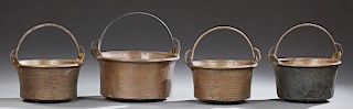 Group of Four Large French Copper Cauldrons, 19th c., with folding iron handles, Largest- H.- 13 1/2 in., W.- 24 1/2 in., D.-
