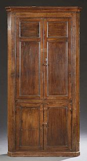 English Carved Oak Corner Cabinet, 19th c., the stepped ogee crown over double two panel doors, above lower double cupboard d