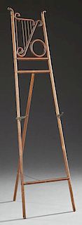 Late Victorian Carved and Bentwood Oak Collapsing Easel, c. 1900, with a spindled lyre form top over iron hooks, and a fold o