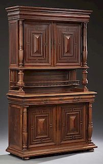 Henri II Style Carved Oak Buffet a Deux Corps, 19th c., the stepped top over double cupboard doors flanked by three reeded pi