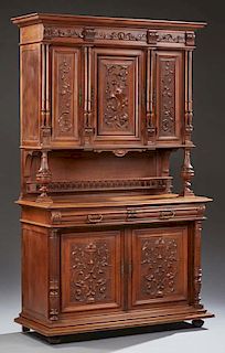 French Carved Cherry Henri II Style Buffet a Deux Corps, c. 1880, the stepped crown over a setback center cupboard flanked by