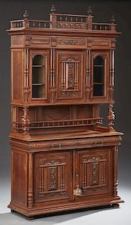 French Henri II Style Buffet a Deux Corps, 19th c., the spindled breakfront crest above a stepped crown over cupboard door wi