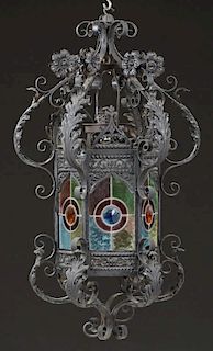 French Stained Glass Wrought Iron Hall Lantern, late 19th c., the leaf and floral supports to a hexagonal lantern with Gothic