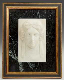 Carved Marble Relief Face of a Classical Woman, 19th c., presented on a verde antico marble slab, within a gilt and ebonized 