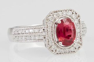 Lady's Platinum Dinner Ring, with an oval 1.04 carats ruby atop an octagonal border of round diamonds, each side of the band 