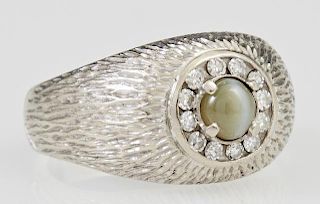 Man's 14K White Gold Dinner Ring, with a cabochon cats eye within a border of small round diamonds, on a Florentine band, tot