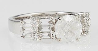 Lady's 18K White Gold Dinner Ring, with a center 1.87 carat round diamond flanked on each side by graduated rows of baguette 