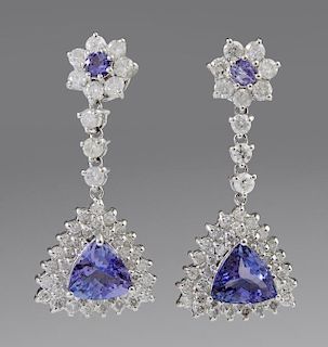 Pair of 14K White Gold Earrings, each with a floriform stud with a central round tanzanite atop a diamond border, suspending 