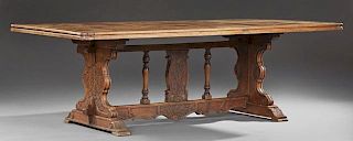 French Carved Walnut Monastery Table, 19th c., the parquetry inlaid reeded edge rounded corner top, on grape carved trestle b