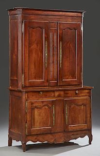 French Provincial Carved Cherry Buffet a Deux Corps, 19th c., the canted corner crown over double doors with long brass escut