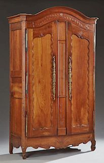 French Provincial Louis XV Style Carved Cherry Armoire, early 19th c., the arched canted corner crown over double arched pane