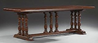 French Henri II Carved Oak Farmhouse Table, 19th c., the thick rounded edge plank top, on spindled trestle bases with turned 