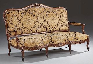 Louis XV Style Carved Walnut Settee, 19th c., the serpentine crest rail over upholstered back, arms, and seat, on scrolled ca