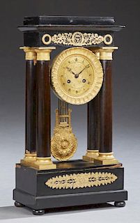 French Gilt Bronze Mounted Ebonized Portico Clock, c. 1870, the stepped top over a bronze mounted frieze above a bronze face,