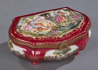 Sevres Style Porcelain and Brass Dresser Box, 20th c., with a magenta ground, the domed lid with a transfer reserve of couple