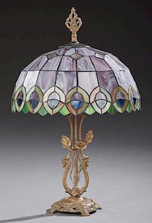 Tiffany Style Slag Glass Table Lamp, late 20th c., the leaded domed slag glass shade on a gilt bronze base with two dragon su