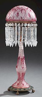 American Pale Cranberry Cut-to-Clear Table Lamp, early 20th c, the domed shade fitting in a metal ring, hung with long button