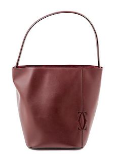 A Cartier Burgundy Calfskin Must-C Bucket Bag, 8" x 11" x 7.5"; Handle drop: 9".