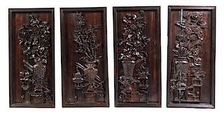 A Set of Four Chinese Carved Hardwood Plaques, Height 34 1/8 x width 16 1/8 inches.