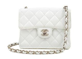 A Chanel White Caviar Mini Cross Body Flap Bag, 6.5" x 5.5" x 2.5"; Strap drop: 21"