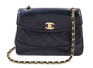 A Chanel Navy Lambskin Flap Shoulder Bag, 9.5" x 6.5" x 3"; Strap drop: 21".