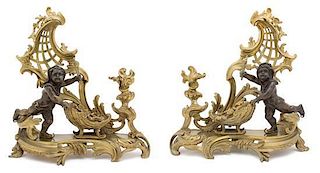A Pair of Louis XV Style Bronze and Gilt Chenets Height 16 x width 15 x depth 7 inches.